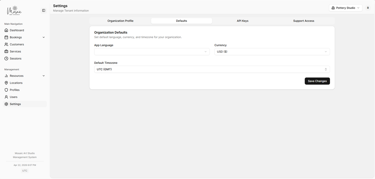 Defaults settings tab with language, currency, and timezone options